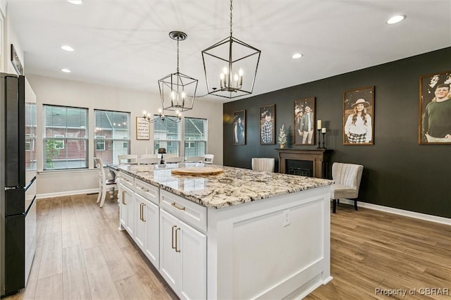 4217 Pillar, Williamsburg, VA 23188 - kitchen featuring freestanding refrigerator, a chandelier, white cabinets, light wood-type flooring, and recessed lighting