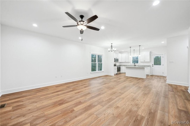 2467 Judes Ferry Rd, Powhatan, VA 23139 - unfurnished living room featuring a chandelier, light wood-style floors, ceiling fan, and recessed lighting