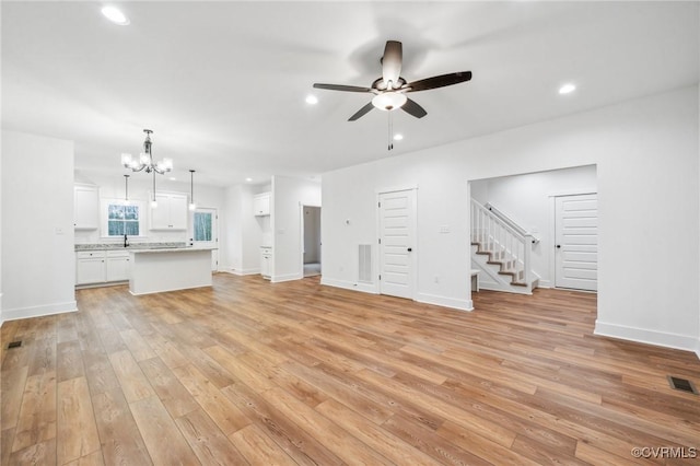 2467 Judes Ferry Rd, Powhatan, VA 23139 - unfurnished living room featuring a chandelier, light wood-style flooring, ceiling fan, stairway, and recessed lighting