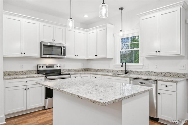 2467 Judes Ferry Rd, Powhatan, VA 23139 - kitchen featuring stainless steel appliances, light wood finished floors, white cabinetry, a kitchen island, and recessed lighting