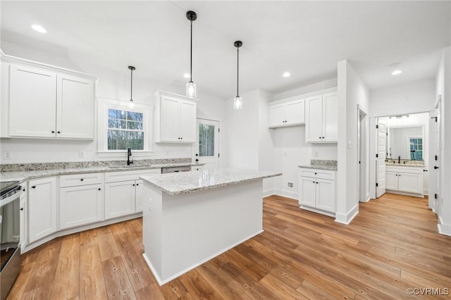 2467 Judes Ferry Rd, Powhatan, VA 23139 - kitchen with white cabinetry, light wood finished floors, recessed lighting, decorative light fixtures, and light stone counters