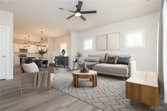 706 S Main St, Blackstone, VA 22824 - living area featuring light wood-style flooring, a chandelier, and ceiling fan
