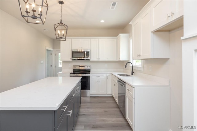706 S Main St, Blackstone, VA 22824 - kitchen featuring stainless steel appliances, a chandelier, white cabinetry, light countertops, and recessed lighting