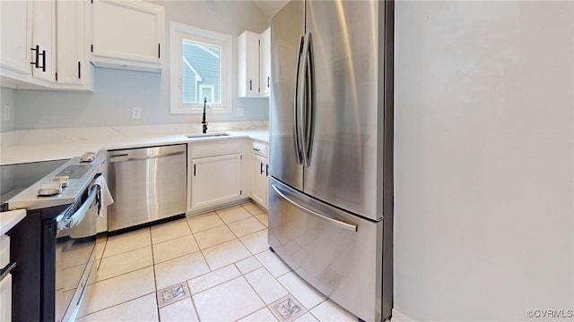 7816 Camolin Ct, Henrico, VA 23228 - kitchen featuring appliances with stainless steel finishes, white cabinetry, light tile patterned floors, and light stone counters