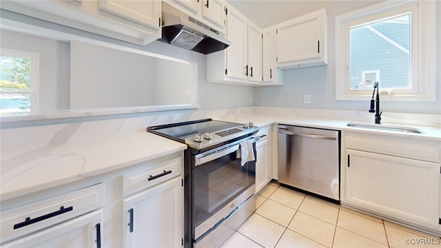 7816 Camolin Ct, Henrico, VA 23228 - kitchen with stainless steel appliances, under cabinet range hood, white cabinetry, light tile patterned floors, and light stone counters