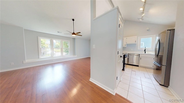 7816 Camolin Ct, Henrico, VA 23228 - kitchen featuring stainless steel appliances, ceiling fan, vaulted ceiling, track lighting, and light countertops