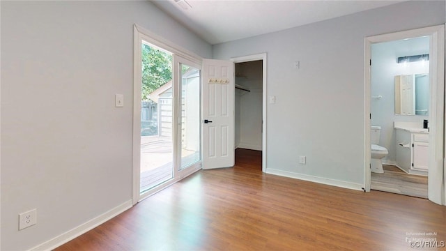 7816 Camolin Ct, Henrico, VA 23228 - unfurnished bedroom with access to exterior, wood finished floors, a walk in closet, and ensuite bath