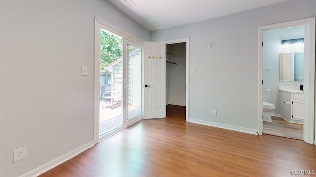 7816 Camolin Ct, Henrico, VA 23228 - unfurnished bedroom with access to exterior, light wood finished floors, a spacious closet, and connected bathroom