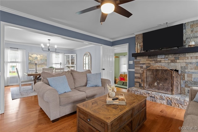 5307 Dermotte Ln, North Chesterfield, VA 23237 - living area with wood finished floors, a ceiling fan, a chandelier, a stone fireplace, and ornamental molding