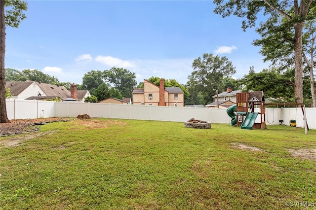 5307 Dermotte Ln, North Chesterfield, VA 23237 - fenced backyard featuring a playground and an outdoor fire pit