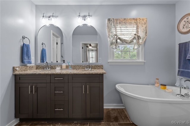 5307 Dermotte Ln, North Chesterfield, VA 23237 - full bathroom with double vanity, a freestanding bath, and a ceiling fan
