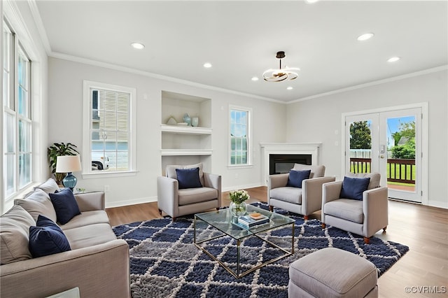 11219 Mill Place Ter, Glen Allen, VA 23060 - living area featuring recessed lighting, wood finished floors, ornamental molding, built in features, and french doors
