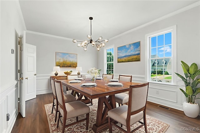 11219 Mill Place Ter, Glen Allen, VA 23060 - dining area with crown molding, a decorative wall, a chandelier, dark wood-type flooring, and wainscoting