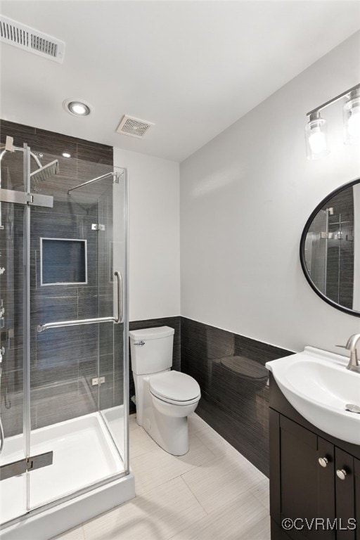 11219 Mill Place Ter, Glen Allen, VA 23060 - bathroom with vanity, wainscoting, a stall shower, tile walls, and recessed lighting
