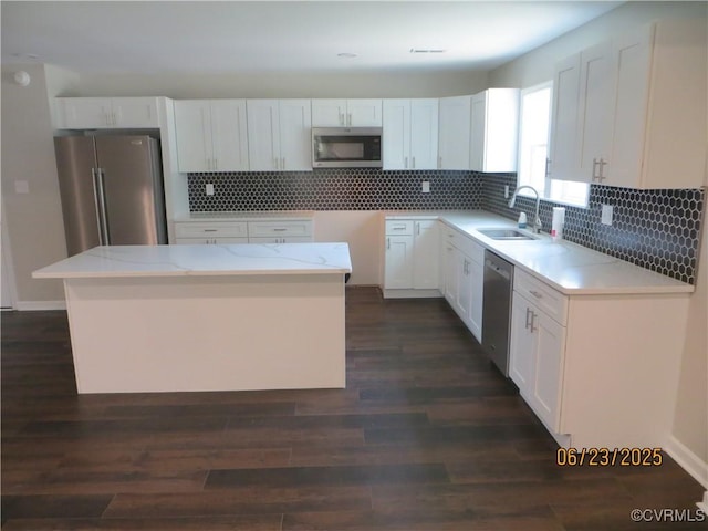 827 Ruthers Rd, North Chesterfield, VA 23235 - kitchen with appliances with stainless steel finishes, white cabinets, tasteful backsplash, and dark wood-style flooring