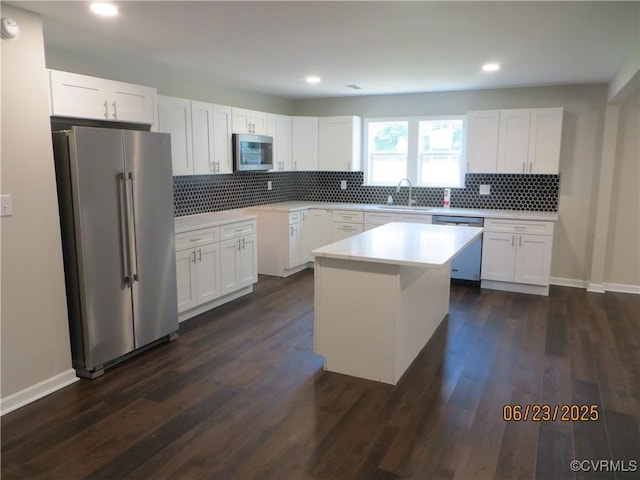 827 Ruthers Rd, North Chesterfield, VA 23235 - kitchen with appliances with stainless steel finishes, white cabinetry, tasteful backsplash, dark wood finished floors, and recessed lighting