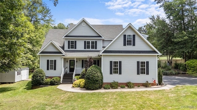 1638 Olde Links Dr, Powhatan, VA 23139 - traditional-style house with roof with shingles, a porch, a front yard, and an outdoor structure