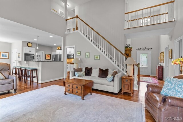 1638 Olde Links Dr, Powhatan, VA 23139 - living area with a towering ceiling, wood finished floors, stairway, and recessed lighting