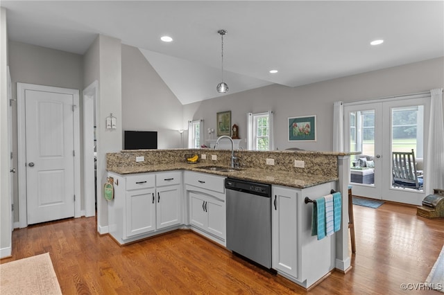 1638 Olde Links Dr, Powhatan, VA 23139 - kitchen featuring stainless steel dishwasher, light wood-style flooring, vaulted ceiling, white cabinets, and stone countertops