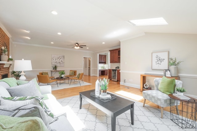 10801 Cherry Hill Dr, Glen Allen, VA 23059 - living room featuring light wood-type flooring, wine cooler, crown molding, a ceiling fan, and a brick fireplace
