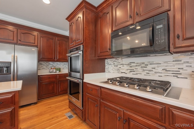 10801 Cherry Hill Dr, Glen Allen, VA 23059 - kitchen with stainless steel appliances, light countertops, decorative backsplash, light wood-style flooring, and crown molding