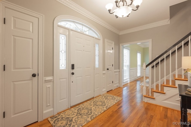 10801 Cherry Hill Dr, Glen Allen, VA 23059 - foyer featuring light wood finished floors, a chandelier, ornamental molding, stairway, and wainscoting
