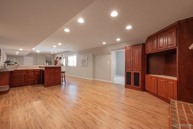 10801 Cherry Hill Dr, Glen Allen, VA 23059 - kitchen featuring light wood-style flooring, recessed lighting, a kitchen breakfast bar, light countertops, and a peninsula
