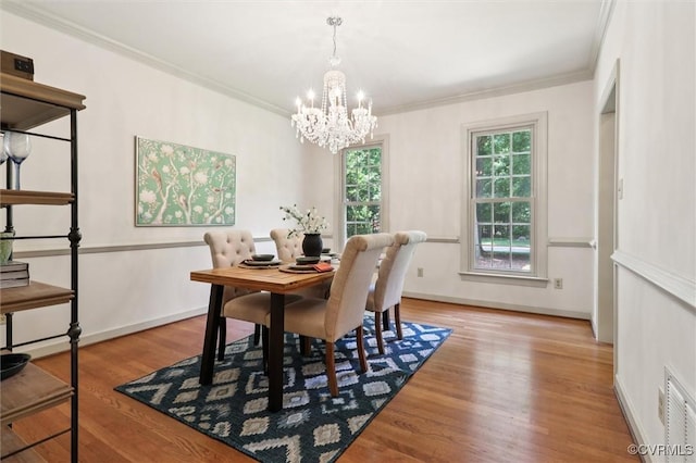 2019 Hornes Lake Rd, Williamsburg, VA 23185 - dining room featuring a chandelier, wood finished floors, and ornamental molding