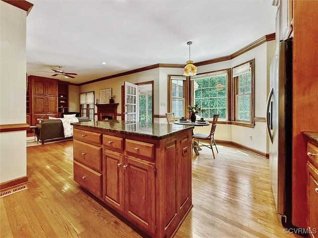 2019 Hornes Lake Rd, Williamsburg, VA 23185 - kitchen with freestanding refrigerator, light wood-style flooring, ornamental molding, a ceiling fan, and decorative light fixtures