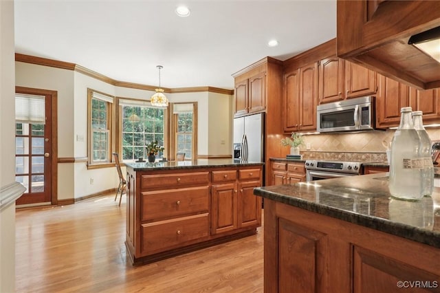 2019 Hornes Lake Rd, Williamsburg, VA 23185 - kitchen featuring stainless steel appliances, dark stone counters, brown cabinets, recessed lighting, and ornamental molding