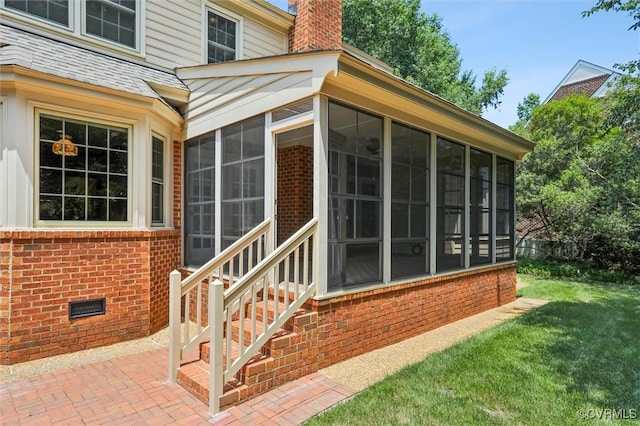 2019 Hornes Lake Rd, Williamsburg, VA 23185 - entrance to property with brick siding, a chimney, a lawn, and a patio