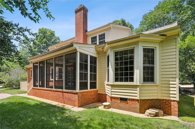 2019 Hornes Lake Rd, Williamsburg, VA 23185 - rear view of property featuring a sunroom, a chimney, and a yard