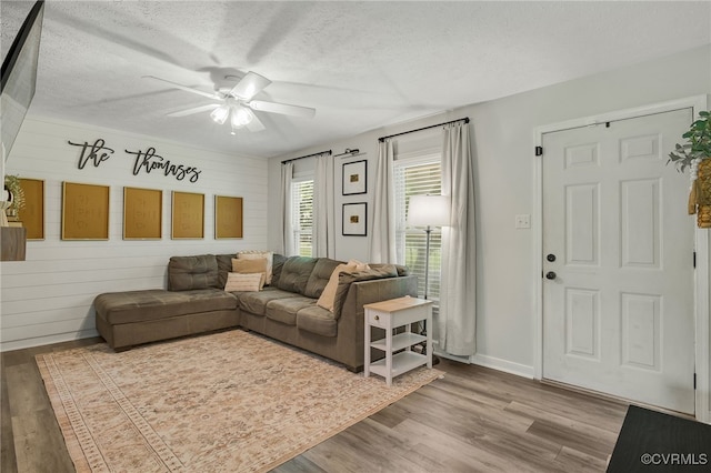 453 Manquin Dr, King William, VA 23009 - living room featuring a ceiling fan, a textured ceiling, wood finished floors, and wooden walls