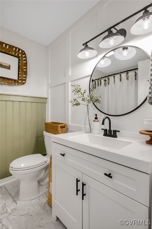 453 Manquin Dr, King William, VA 23009 - full bathroom with marble finish floors, vanity, a wainscoted wall, and a decorative wall