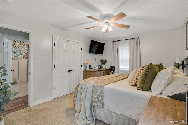 453 Manquin Dr, King William, VA 23009 - bedroom featuring a closet, a ceiling fan, light wood finished floors, a textured ceiling, and light carpet