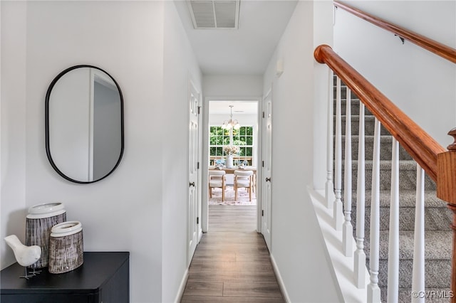 4107 Forest Vine Pl, Chesterfield, VA 23834 - hallway with wood finished floors, stairway, and a chandelier