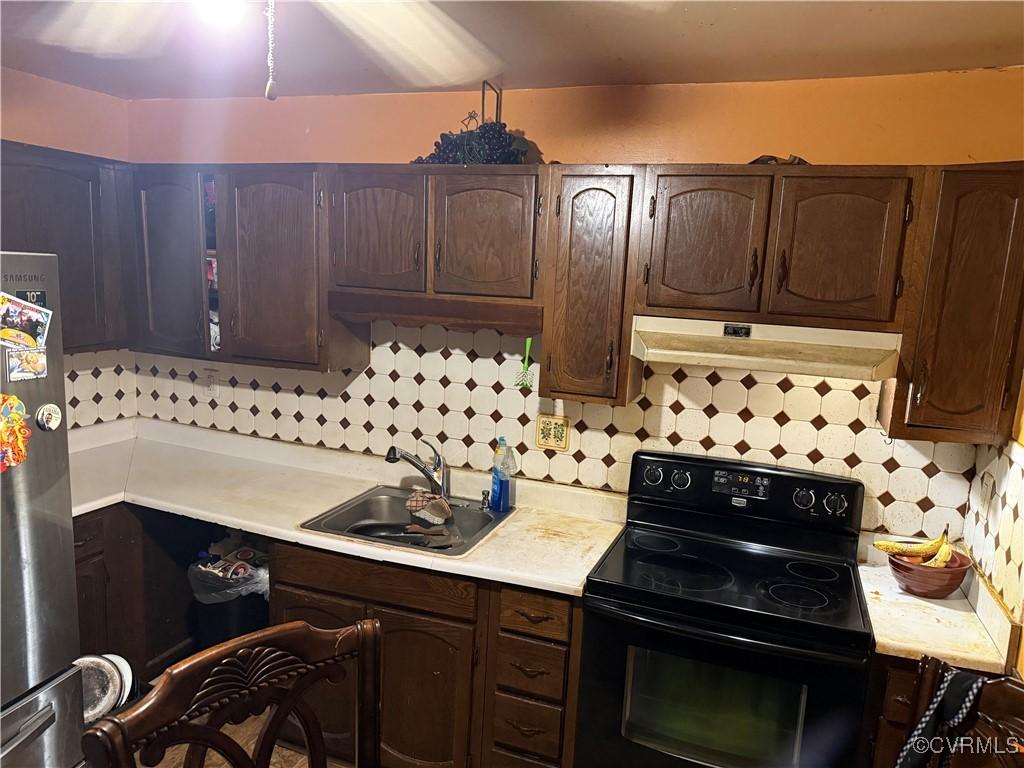 6217 Meadwood Cir, North Chesterfield, VA 23234 - kitchen with black range with electric stovetop, under cabinet range hood, light countertops, and freestanding refrigerator