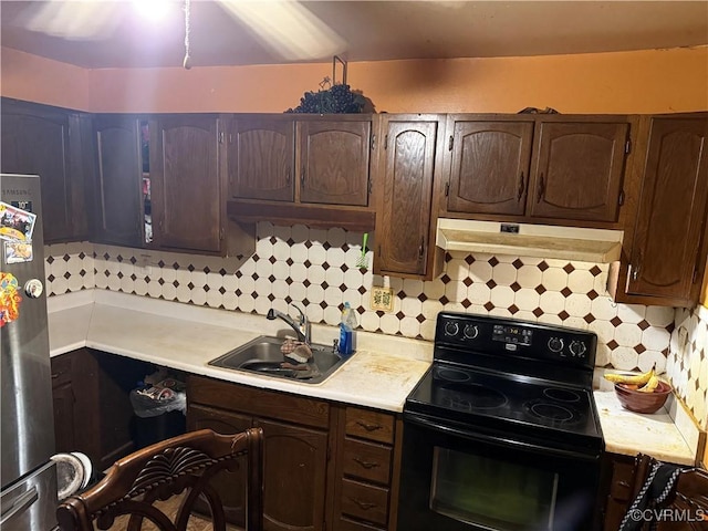 6217 Meadwood Cir, North Chesterfield, VA 23234 - kitchen with black range with electric stovetop, under cabinet range hood, light countertops, and freestanding refrigerator