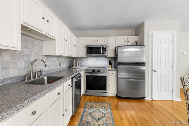 14715 Boyces Cove Dr, Midlothian, VA 23112 - kitchen featuring appliances with stainless steel finishes, white cabinets, backsplash, and light wood-style floors