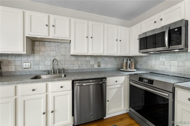 14715 Boyces Cove Dr, Midlothian, VA 23112 - kitchen with appliances with stainless steel finishes, white cabinets, decorative backsplash, and dark wood-style floors