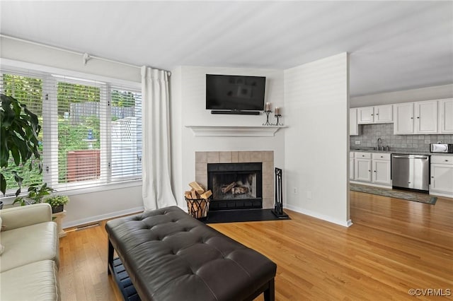 14715 Boyces Cove Dr, Midlothian, VA 23112 - living area with a tile fireplace and light wood-style flooring