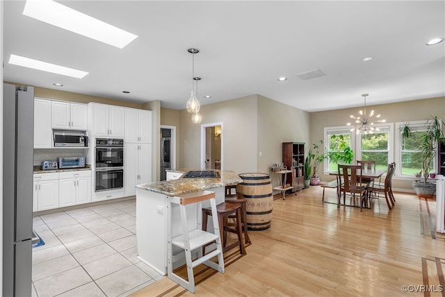10598 Lambeth Rd, Glen Allen, VA 23060 - kitchen featuring appliances with stainless steel finishes, a chandelier, white cabinetry, a center island, and recessed lighting
