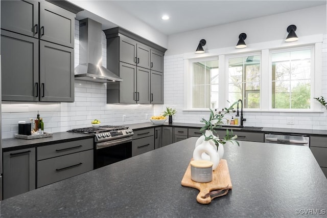 2114 N Ave, Richmond, VA 23222 - kitchen with wall chimney exhaust hood, stainless steel appliances, dark countertops, backsplash, and recessed lighting