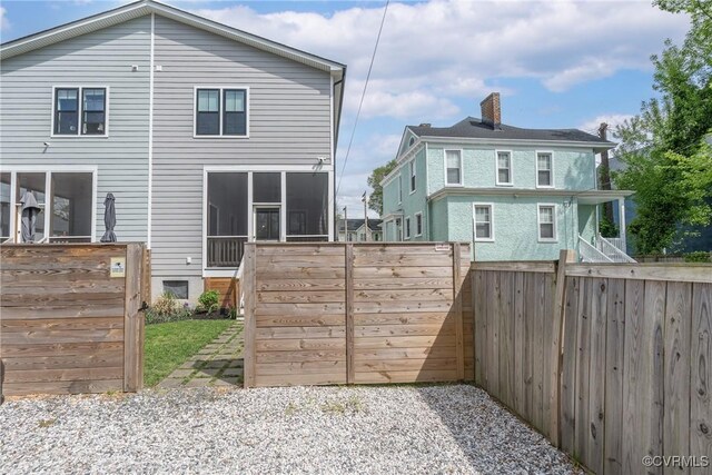 2114 N Ave, Richmond, VA 23222 - rear view of house featuring a sunroom and a chimney