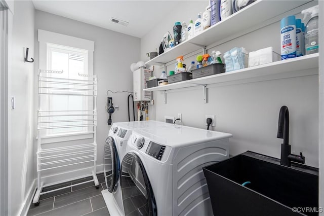 2114 N Ave, Richmond, VA 23222 - laundry area with washer and clothes dryer, dark tile patterned floors, and water heater