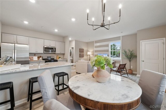 6021 Banyan Ln, Chesterfield, VA 23234 - dining space with a chandelier, light wood-style flooring, and recessed lighting