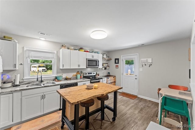 520 Monte Verde Rd, Center Cross, VA 22437 - kitchen with appliances with stainless steel finishes, white cabinets, and light wood-type flooring