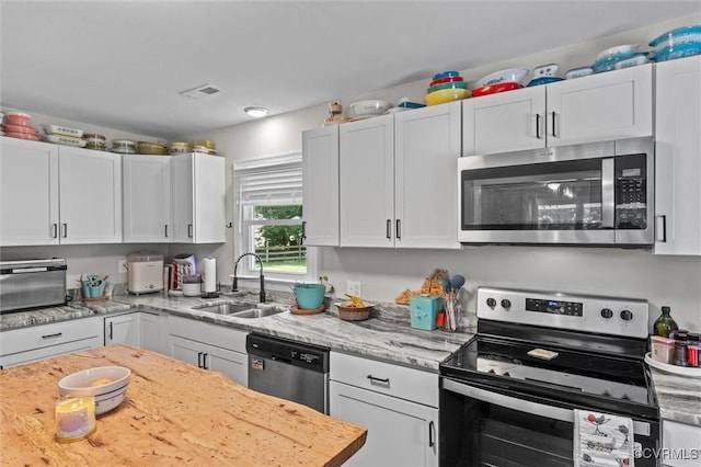 520 Monte Verde Rd, Center Cross, VA 22437 - kitchen with appliances with stainless steel finishes, white cabinets, and light stone countertops