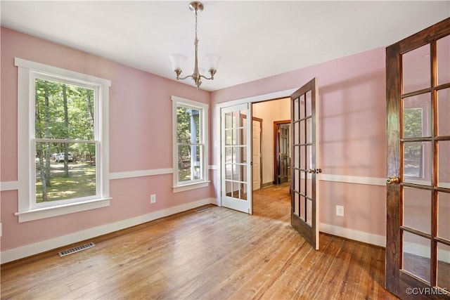 3180 Judes Ferry Rd, Powhatan, VA 23139 - spare room featuring french doors, a chandelier, and wood-type flooring