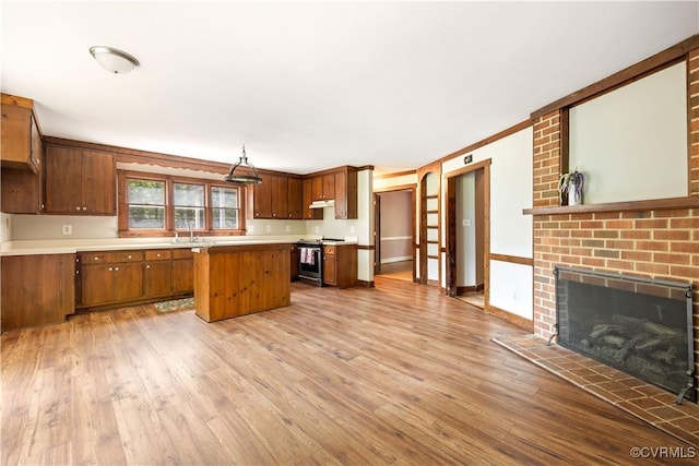 3180 Judes Ferry Rd, Powhatan, VA 23139 - kitchen featuring stainless steel electric range oven, a kitchen island, wood-type flooring, and brown cabinets